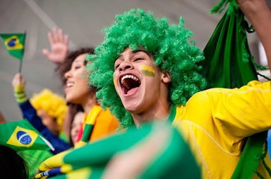 Ecstatic brazilian fan watching a football game, World Cup